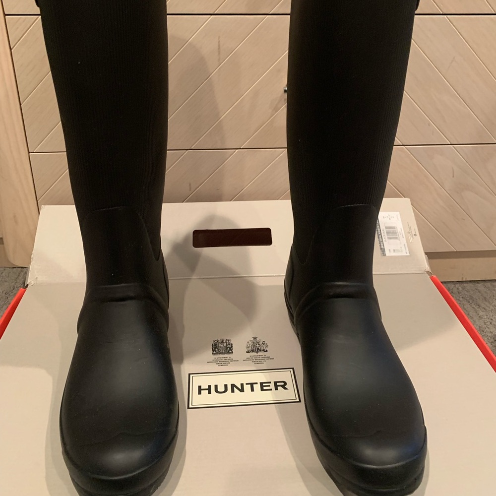 Hunter high black rain boots.